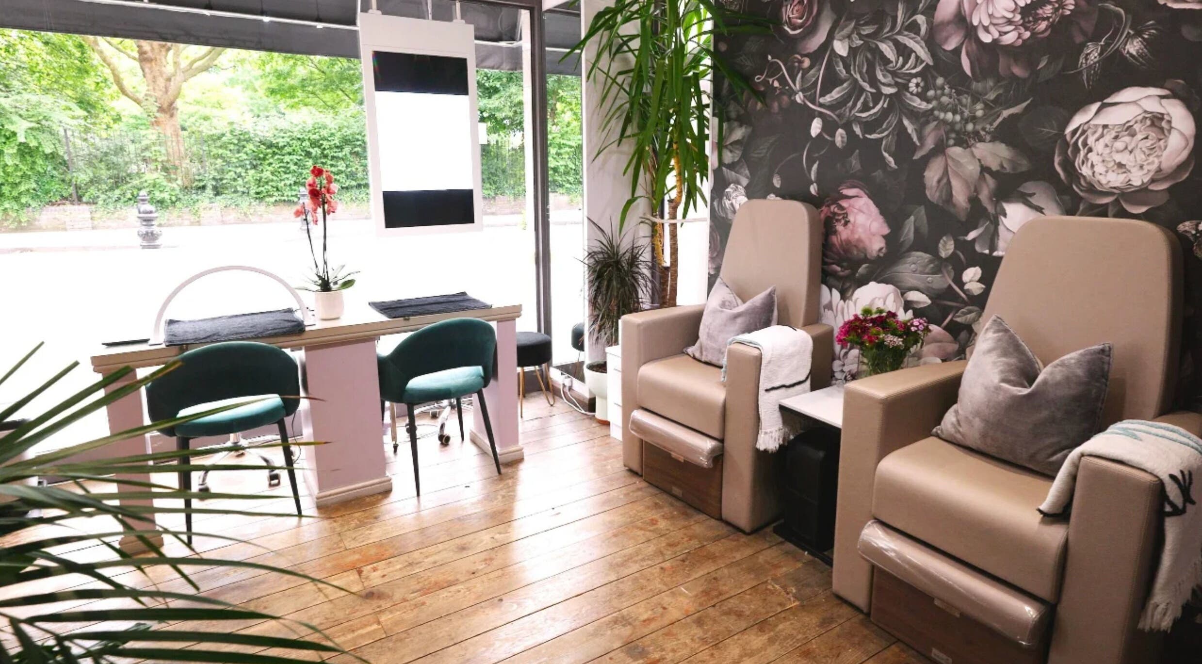 Relax in plush chairs at Elena Von London, a serene beauty salon in London, England, GB with elegant floral decor.