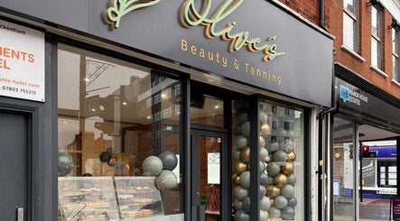 Olive's Beauty & Tanning - Beckenham storefront in Beckenham, England, GB, showcasing balloons and signage.