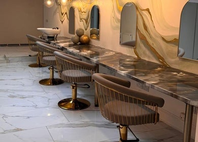 Chic salon at Olive's Beauty & Tanning - Beckenham with elegant chairs and mirrors. Located in Beckenham, England, GB.