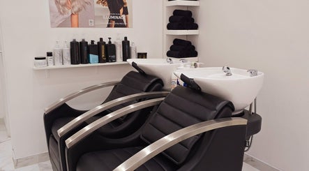 Modern hair wash stations at London City Hair Salon Limited, London, England, GB, showcasing sleek design.