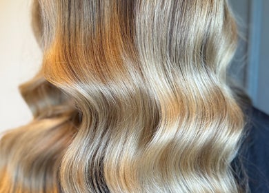 Blonde wavy hair styled at Studio 94 Hairdressing, Westport, County Mayo, IE, showcasing vibrant color and shine.