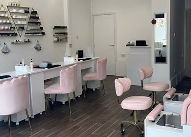 Elegant interior of Pinky Bar in Bristol, England, GB with plush pink chairs and nail stations.