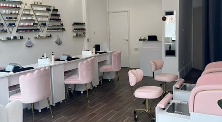 Elegant interior of Pinky Bar in Bristol, England, GB with plush pink chairs and nail stations.