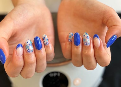 Colorful nail art featuring blue and polka dots at Pinky Bar, Bristol, England, GB.