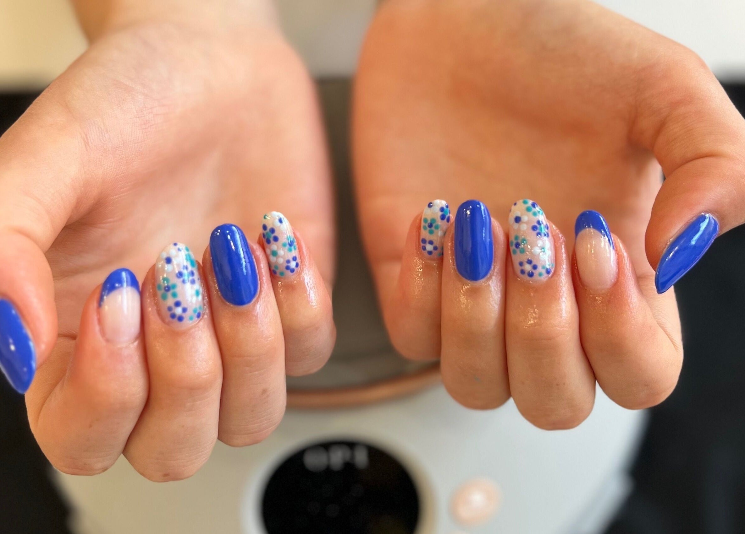 Vibrant blue and floral nail art at Pinky Bar, Bristol, England, GB. Chic and modern nail styles.