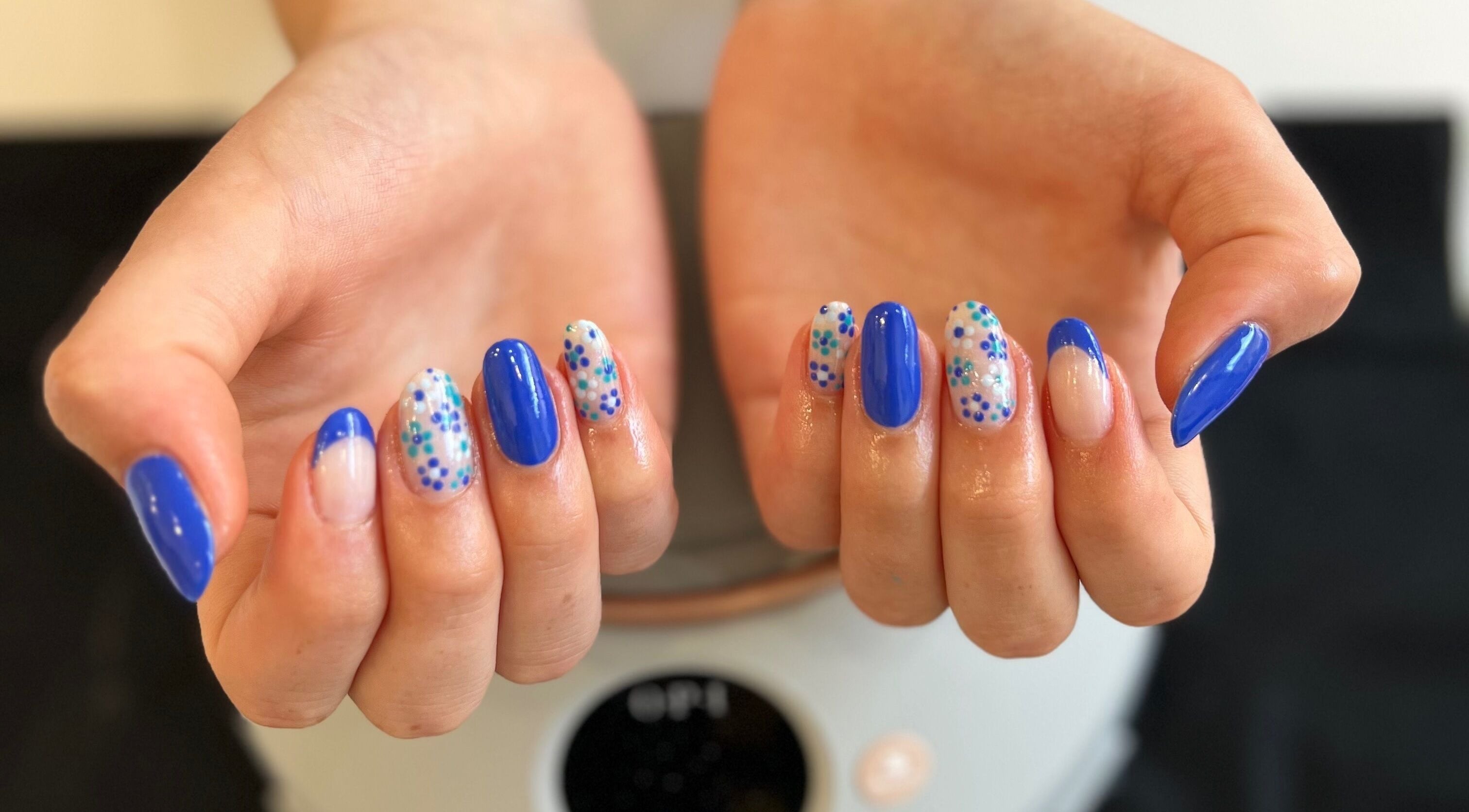 Vibrant blue and floral nail art at Pinky Bar, Bristol, England, GB. Chic and modern nail styles.