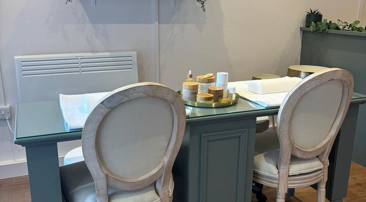 Elegant spa table setup at Belle, Otley, England, GB, with plush chairs and skincare products.