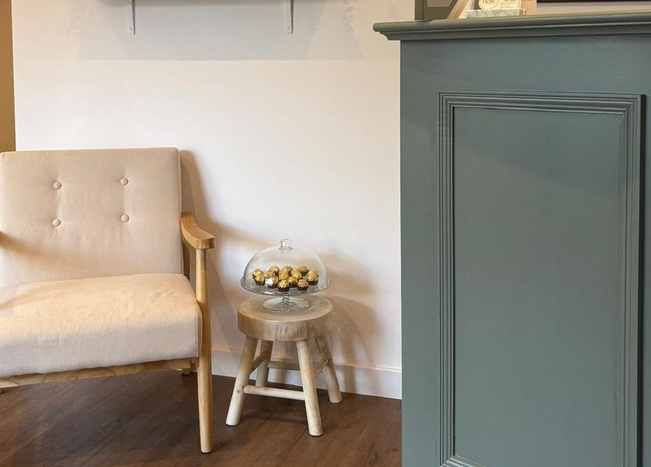 Cozy seating area at Belle in Otley, England, GB, featuring a plush chair and a mini table with chocolates.