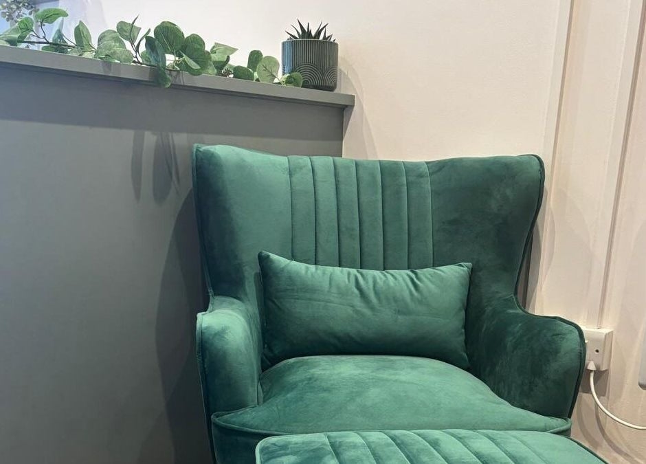 Elegant green velvet chair at Belle, Otley, England, GB, offering a cozy and relaxing atmosphere.