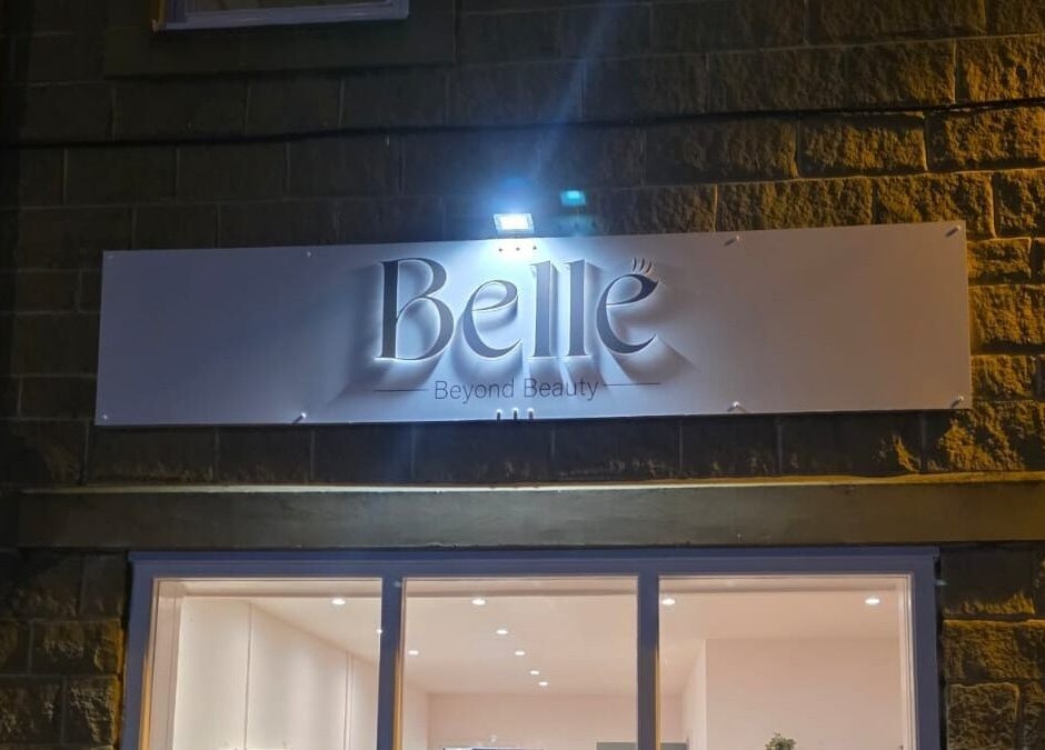 Illuminated Belle sign at night in Otley, England, GB showcasing beauty and wellness venue elegance.