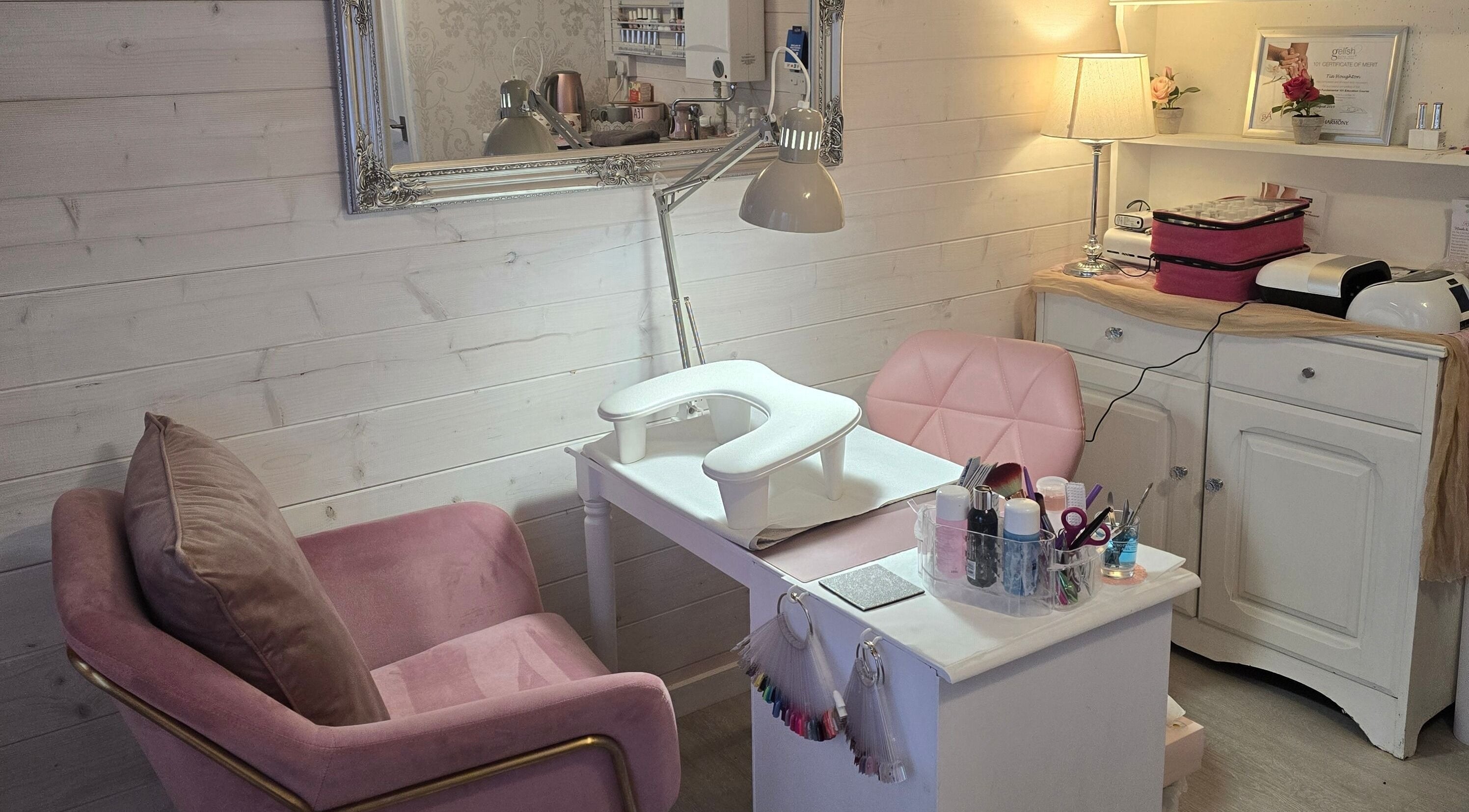Chic nail salon setup at Rose Lodge Beauty, Beccles, England, GB featuring pink chairs and manicure station.