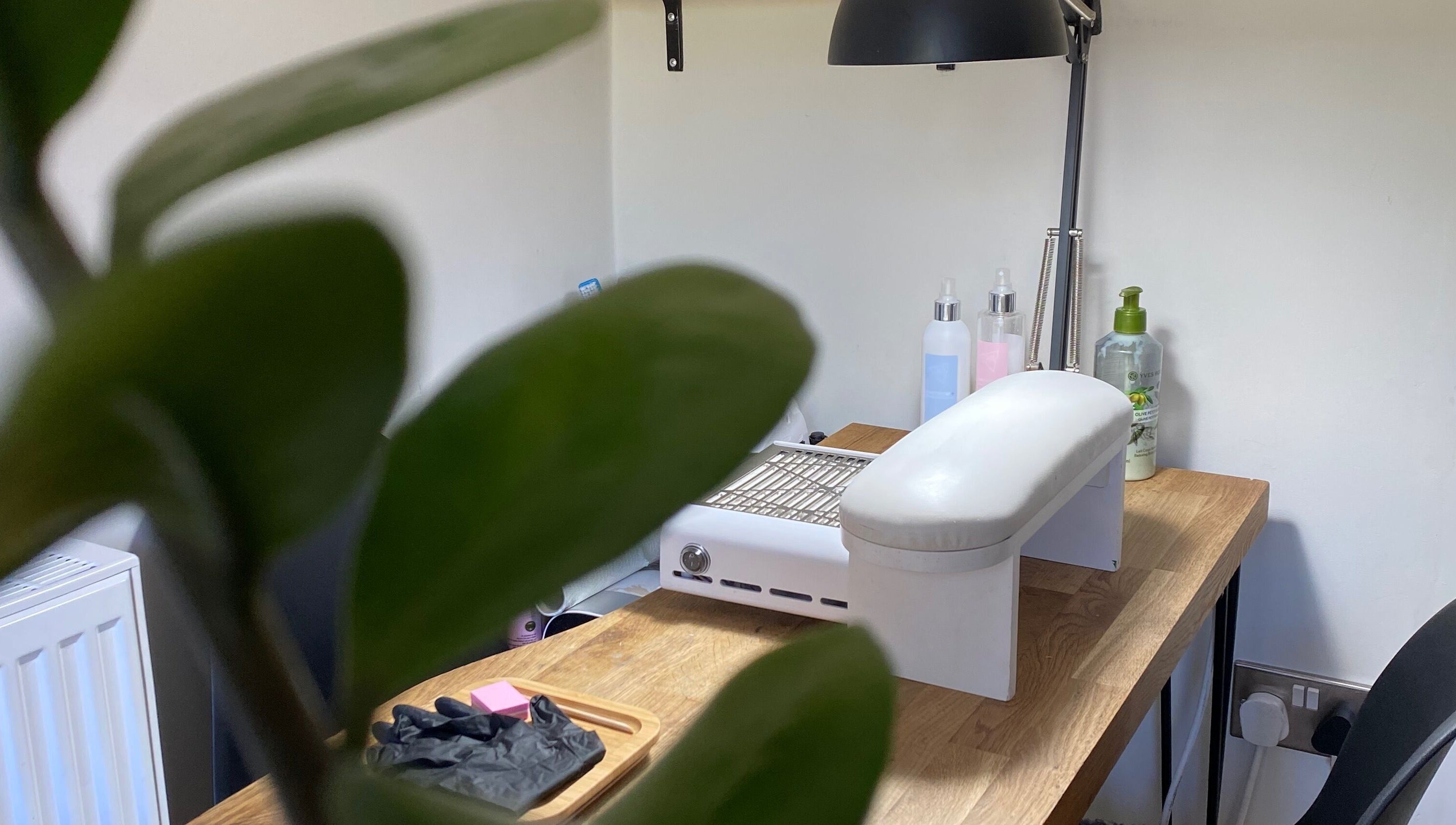 Nail station at Milanailed_it, Bristol, England, GB highlighted by fresh greenery.