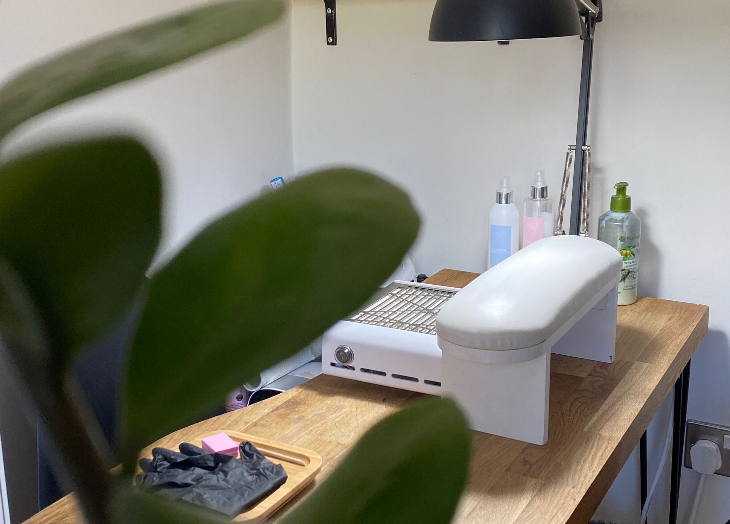 Nail station at Milanailed_it, Bristol, England, GB highlighted by fresh greenery.