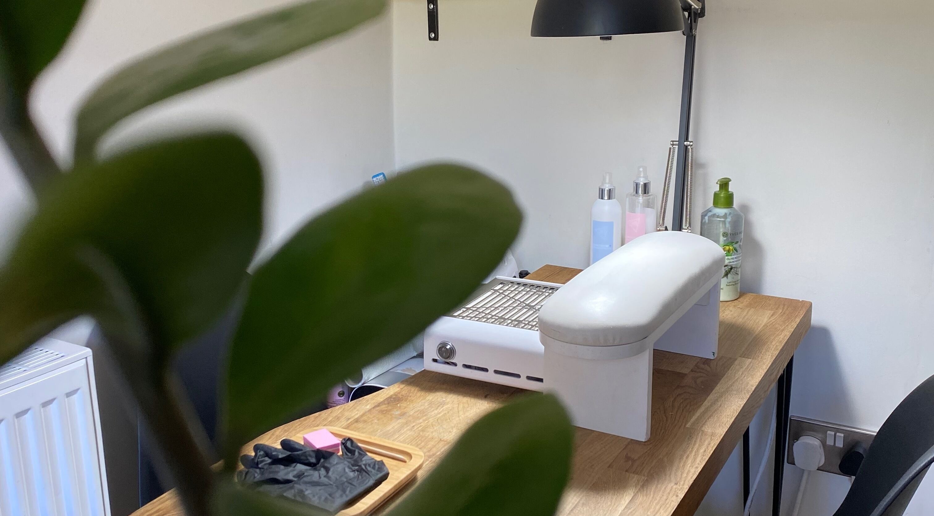 Nail station at Milanailed_it, Bristol, England, GB highlighted by fresh greenery.