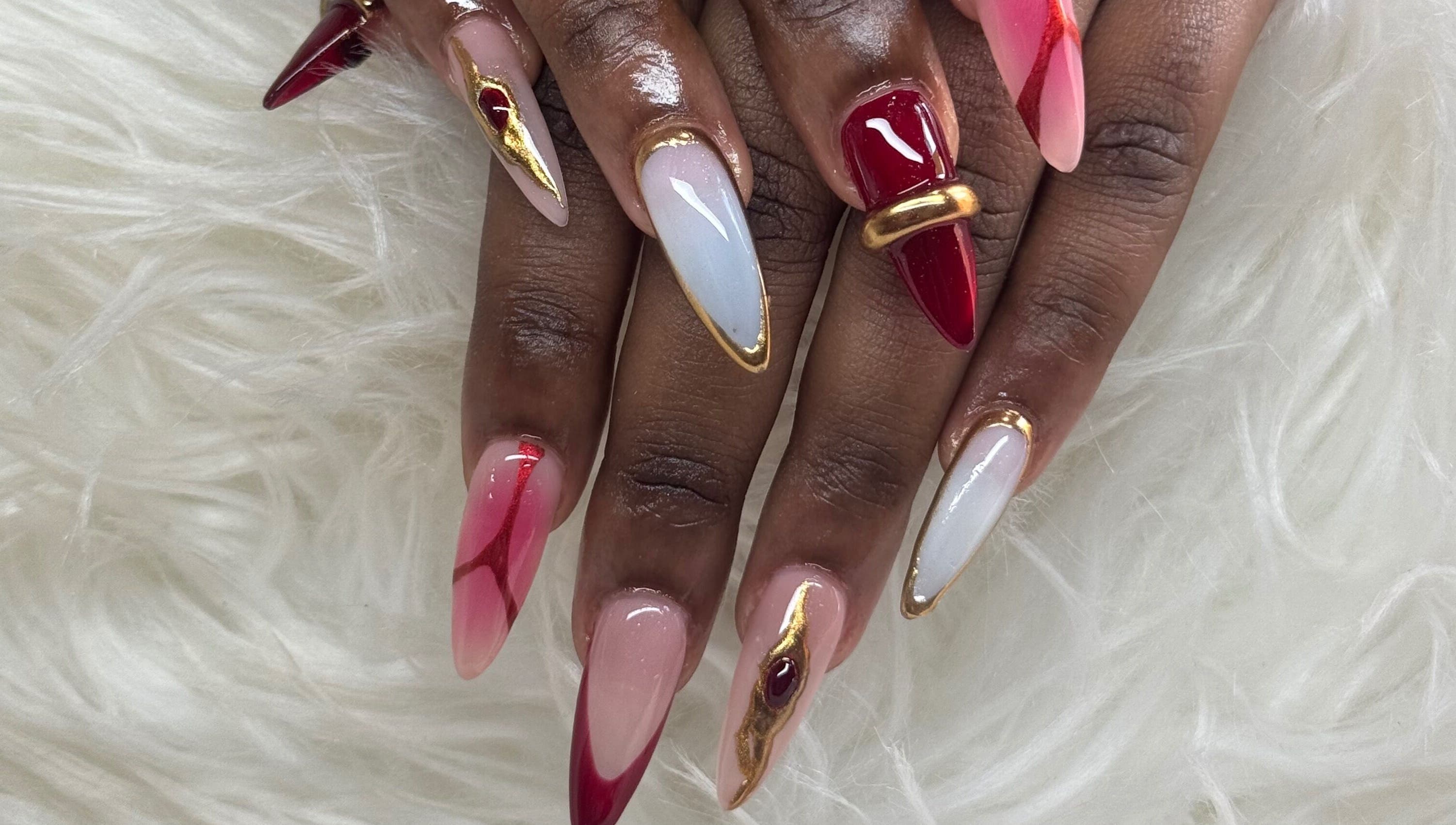 Stylish nail art with red and gold details from Nails by Dark.Indi, Kingston, St. Andrew Parish, JM.