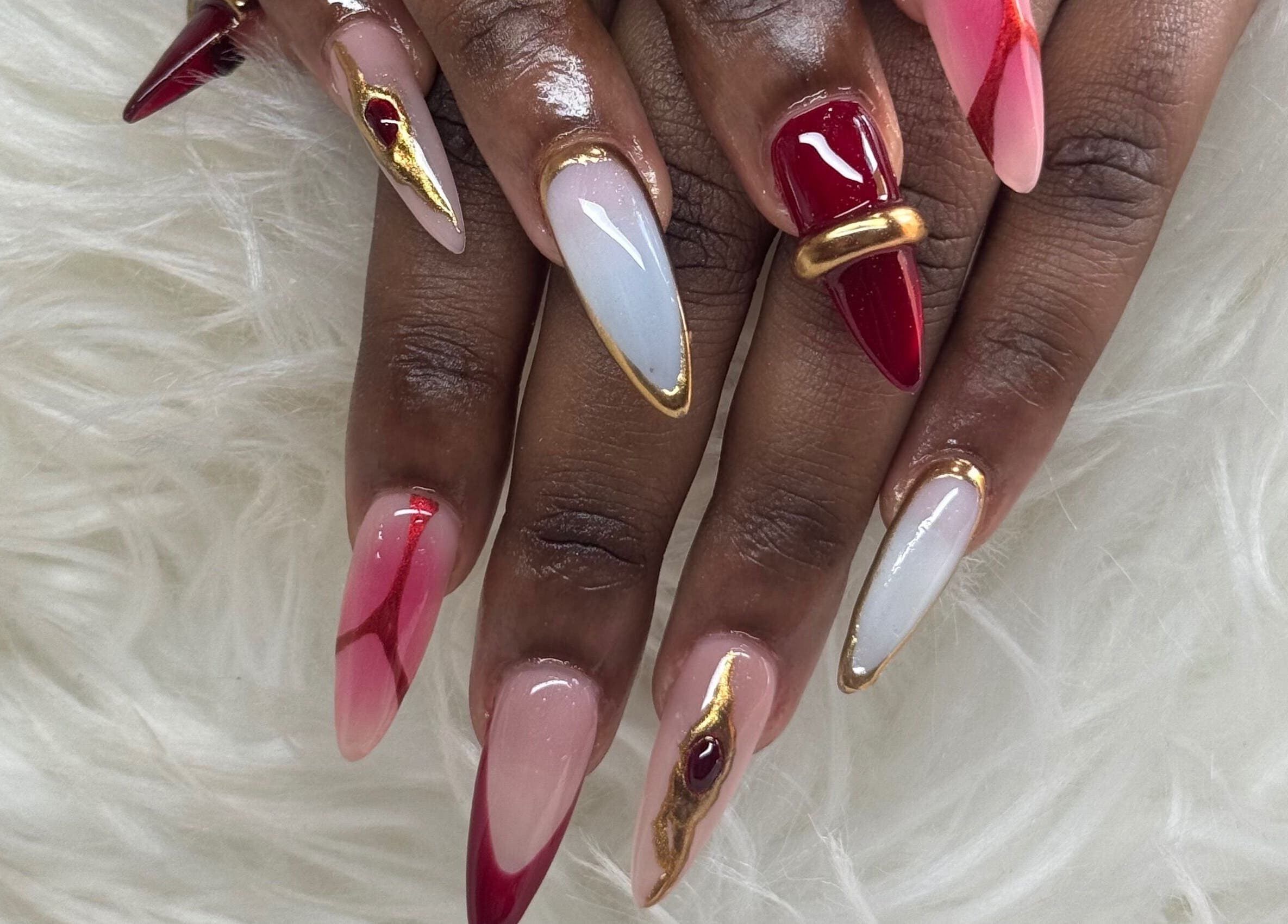 Stylish nail art with red and gold details from Nails by Dark.Indi, Kingston, St. Andrew Parish, JM.