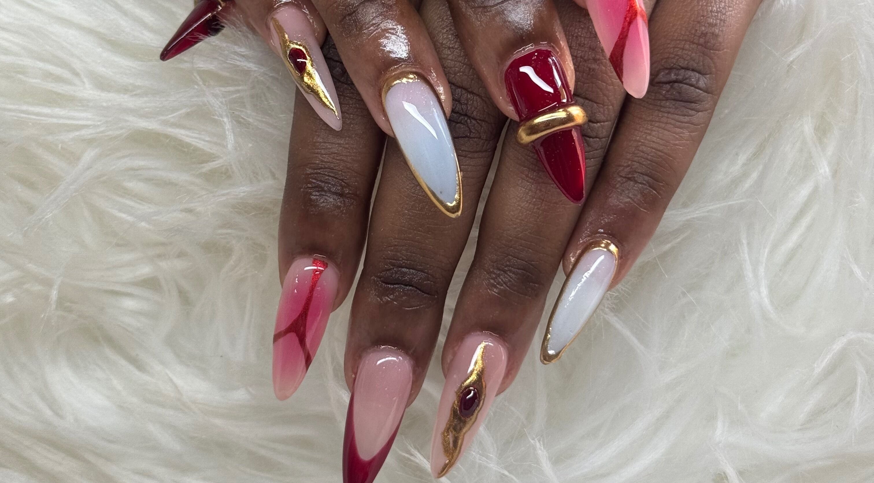 Stylish nail art with red and gold details from Nails by Dark.Indi, Kingston, St. Andrew Parish, JM.