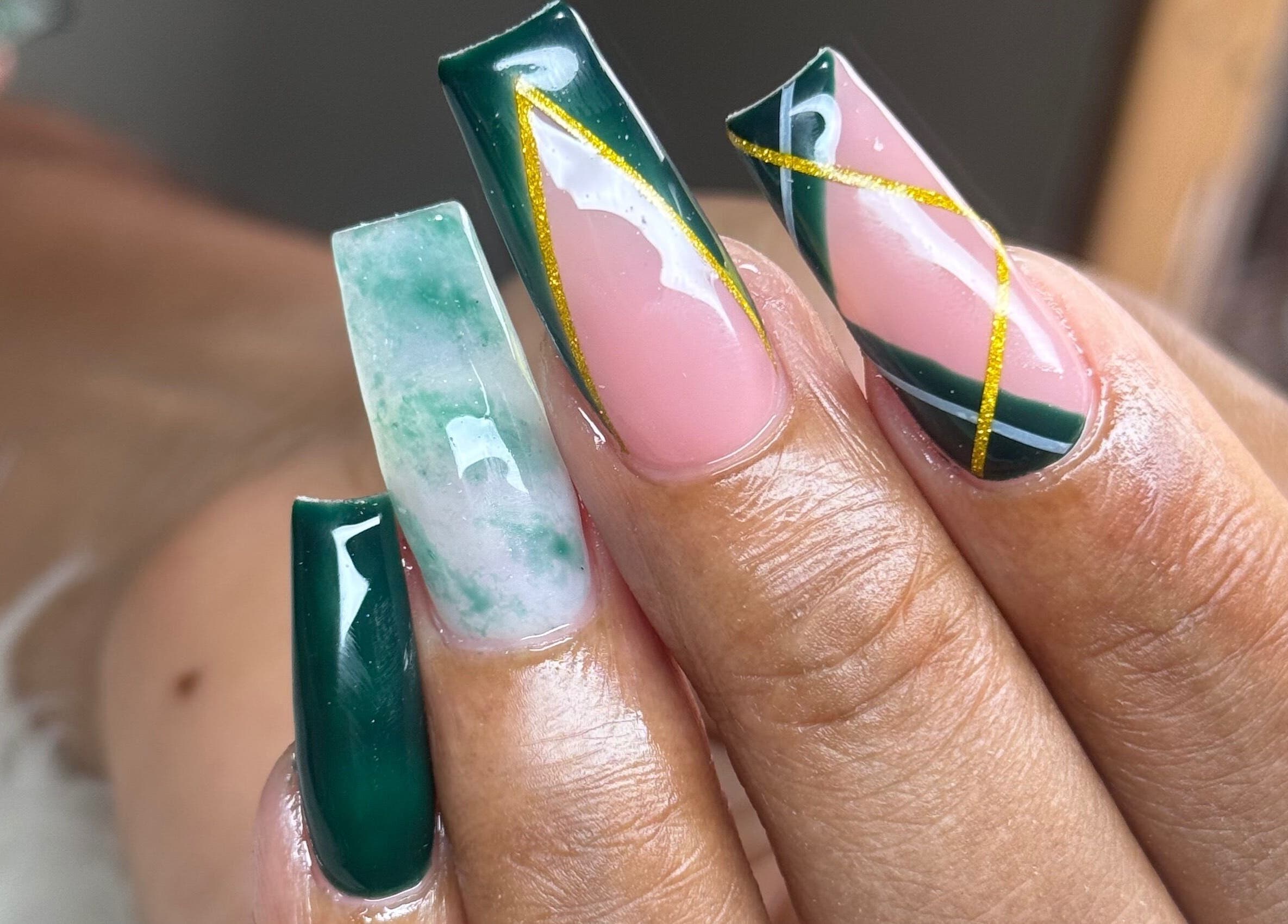Elegant nail art at Nails by Dark.Indi, Kingston, St. Andrew Parish, JM, featuring green and gold accents.