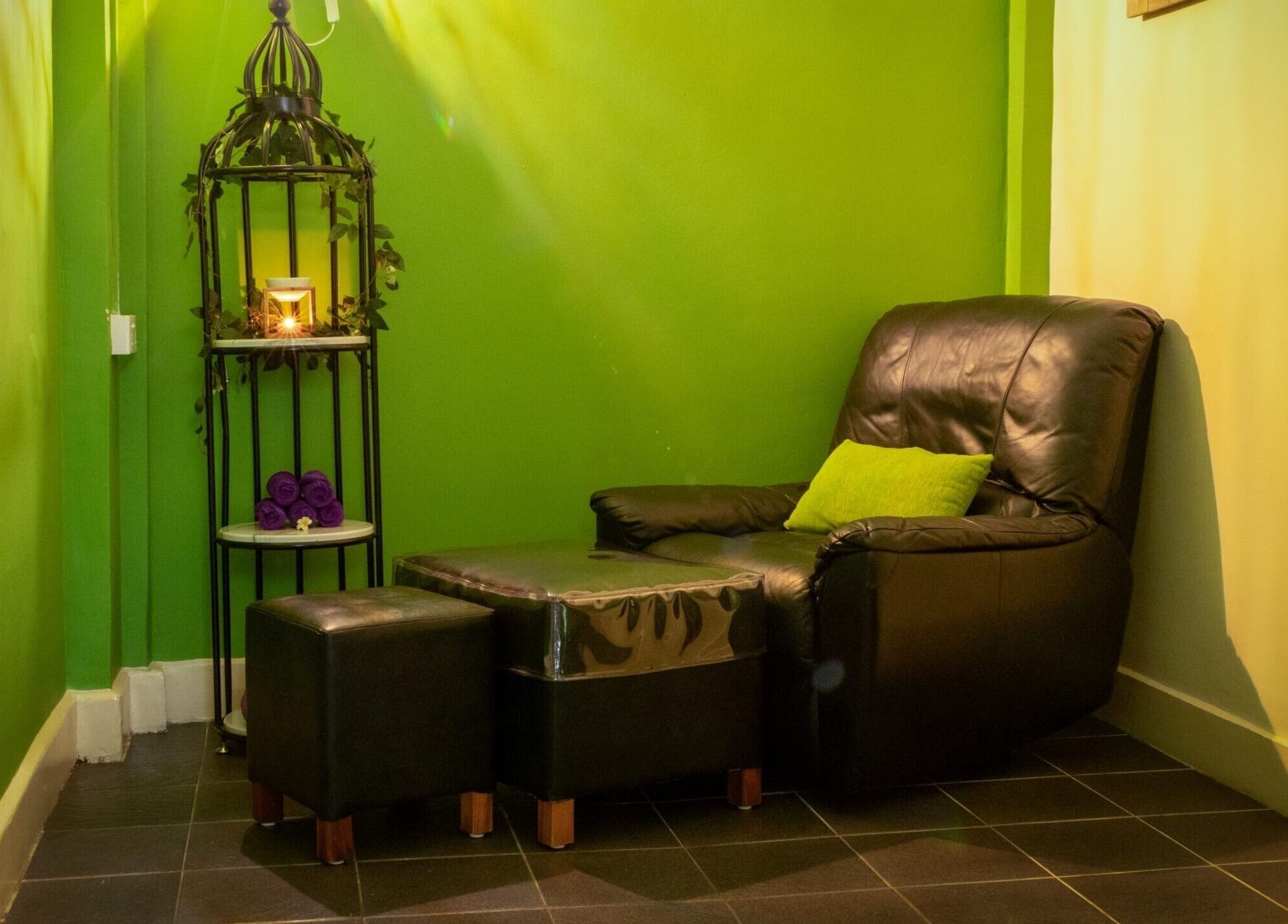 Cozy relaxation corner at The Spa in Díli, Dili, TL with leather chair and ambient lighting.