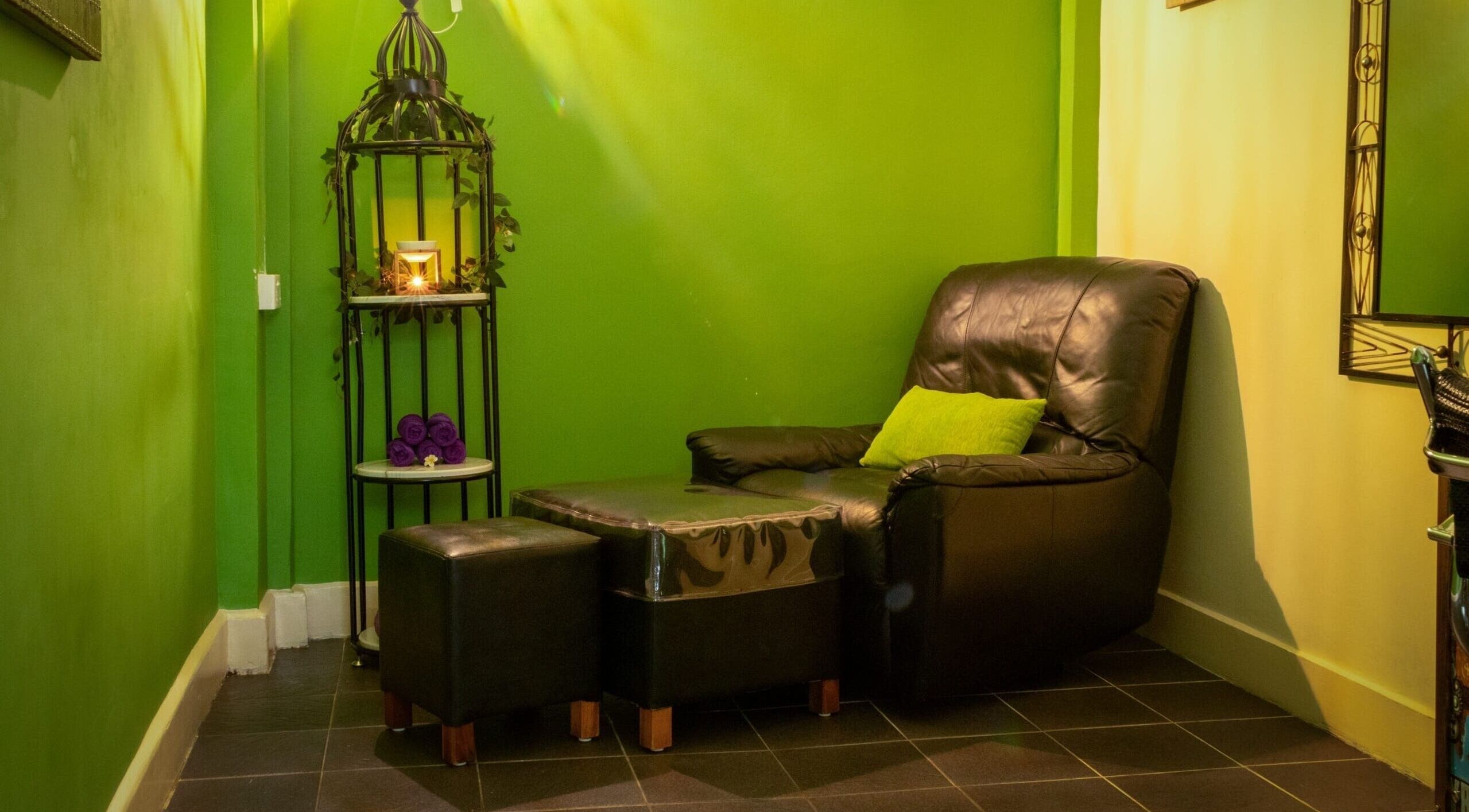 Cozy relaxation corner at The Spa in Díli, Dili, TL with leather chair and ambient lighting.