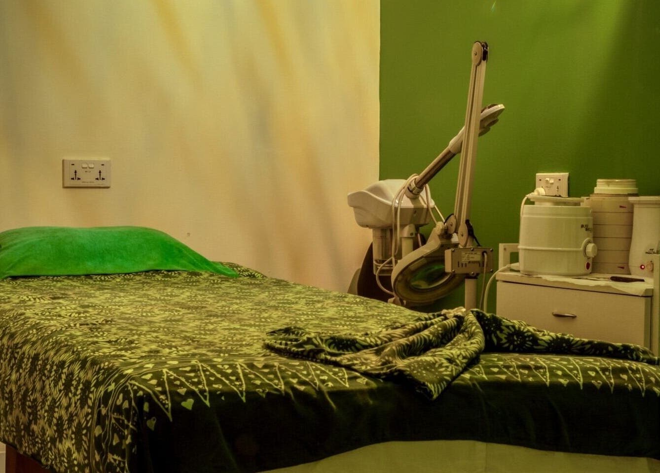 Relaxing treatment room at The Spa, Díli, Dili, TL with a cozy massage bed and calming green decor.