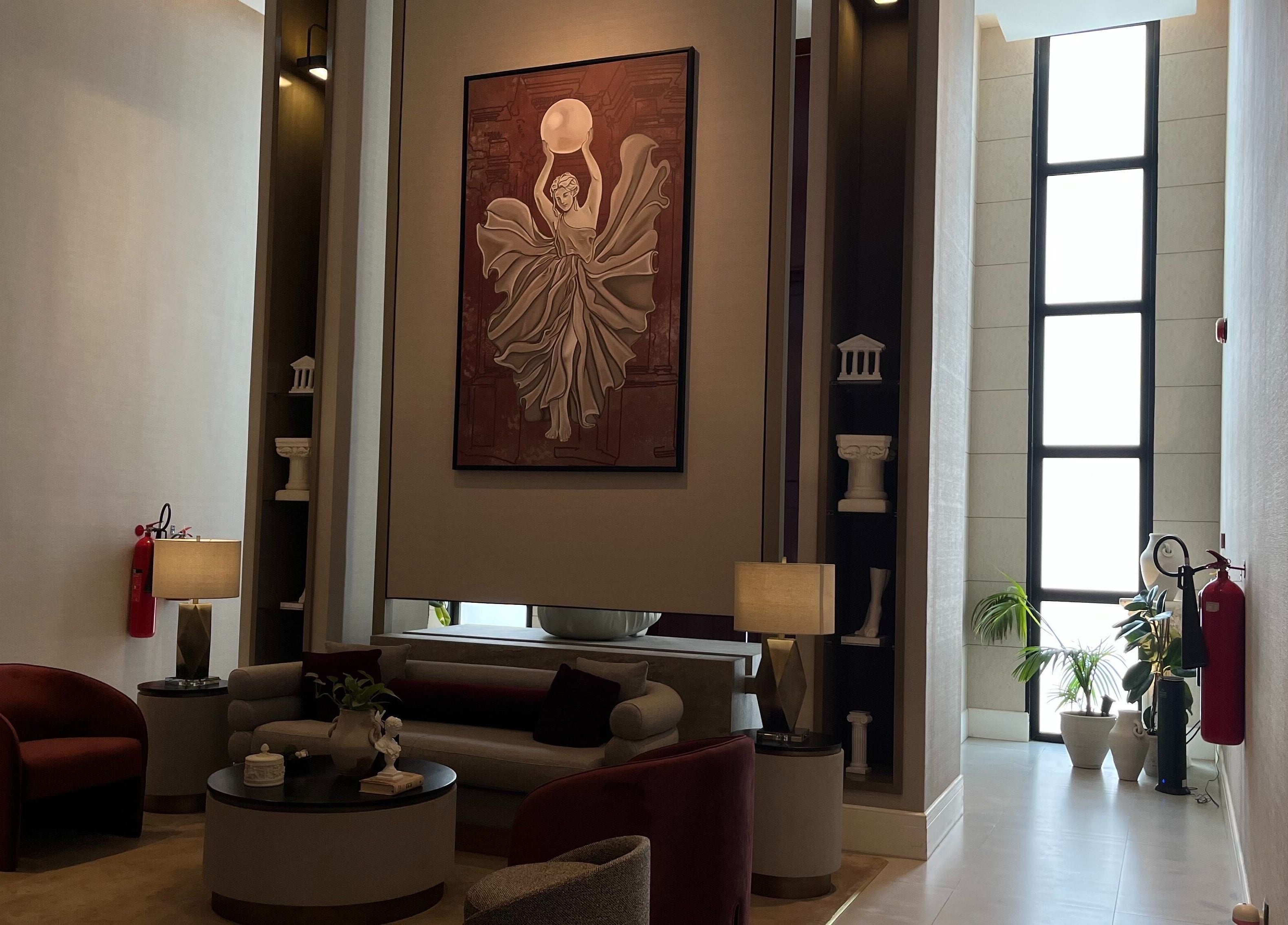 Elegant lounge area at Myalo Spa, Riyadh, showcasing a large art piece and modern decor.