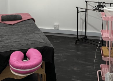 Massage room at Beauty Defined By Cindy G, Gqeberha, Eastern Cape, ZA with a treatment bed and organized supplies.