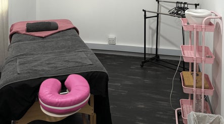 Massage room at Beauty Defined By Cindy G, Gqeberha, Eastern Cape, ZA with a treatment bed and organized supplies.