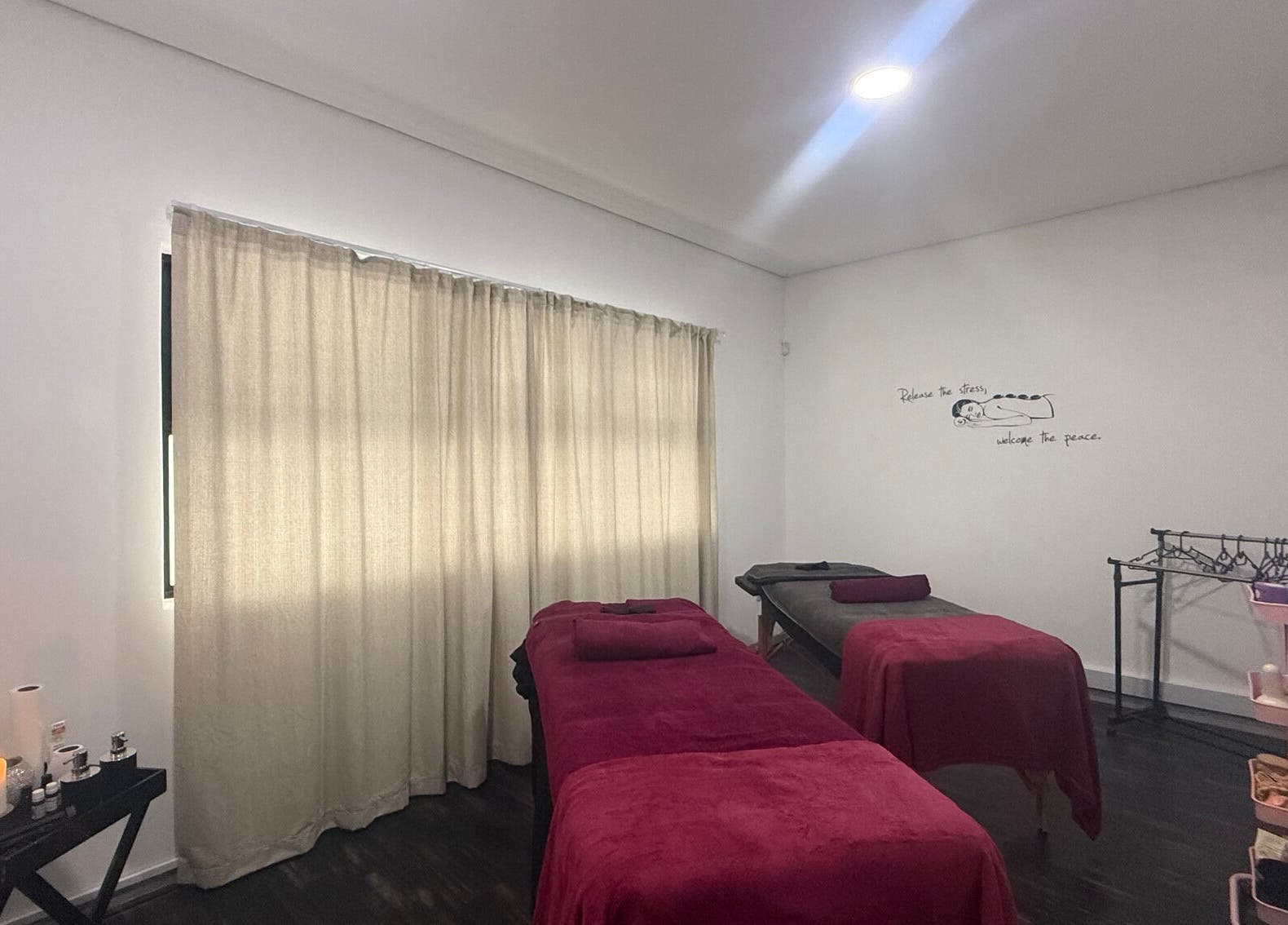 Massage room with red linens at Beauty Defined By Cindy G in Gqeberha, Eastern Cape, ZA.