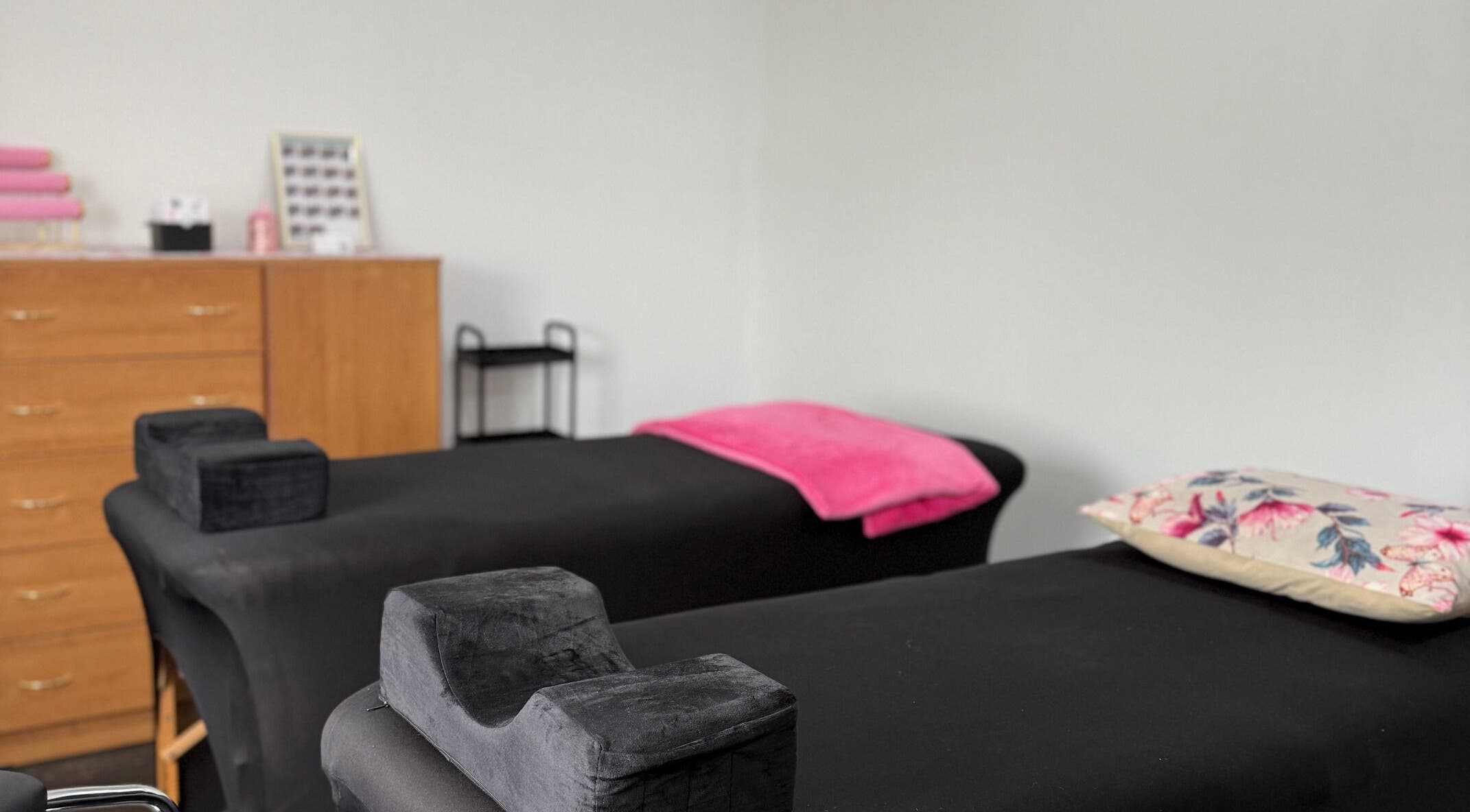 Relaxing spa treatment room at Beauty Defined By Cindy G in Gqeberha, Eastern Cape, ZA, featuring massage beds.