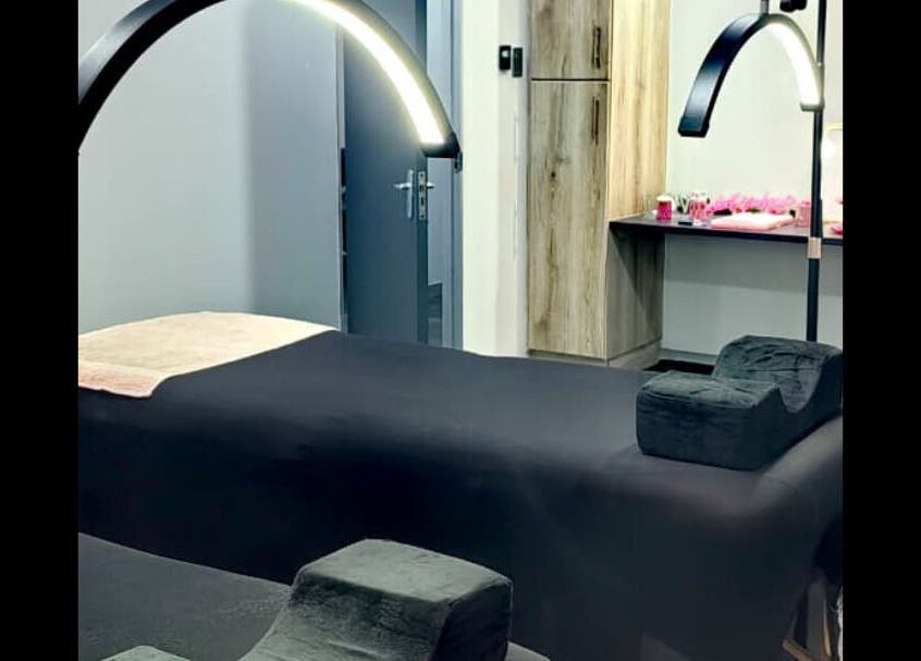 Relaxing massage room at Beauty Defined By Cindy G in Gqeberha, Eastern Cape, ZA with stylish black decor.