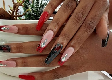 Stylish manicure with red and black nail art at The Beauty Salon & Company, Roodepoort, Gauteng, ZA.