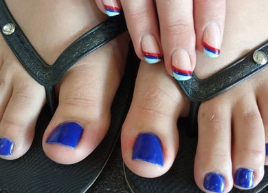 Colorful nails at The Beauty Salon & Company in Roodepoort, Gauteng, ZA, showcasing creative pedicure designs.
