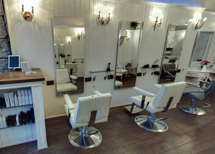 Elegant salon interior at Hair by Boom, Edinburgh, Scotland, GB, featuring stylish chairs and mirrors.
