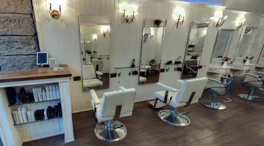 Elegant salon interior at Hair by Boom, Edinburgh, Scotland, GB, featuring stylish chairs and mirrors.