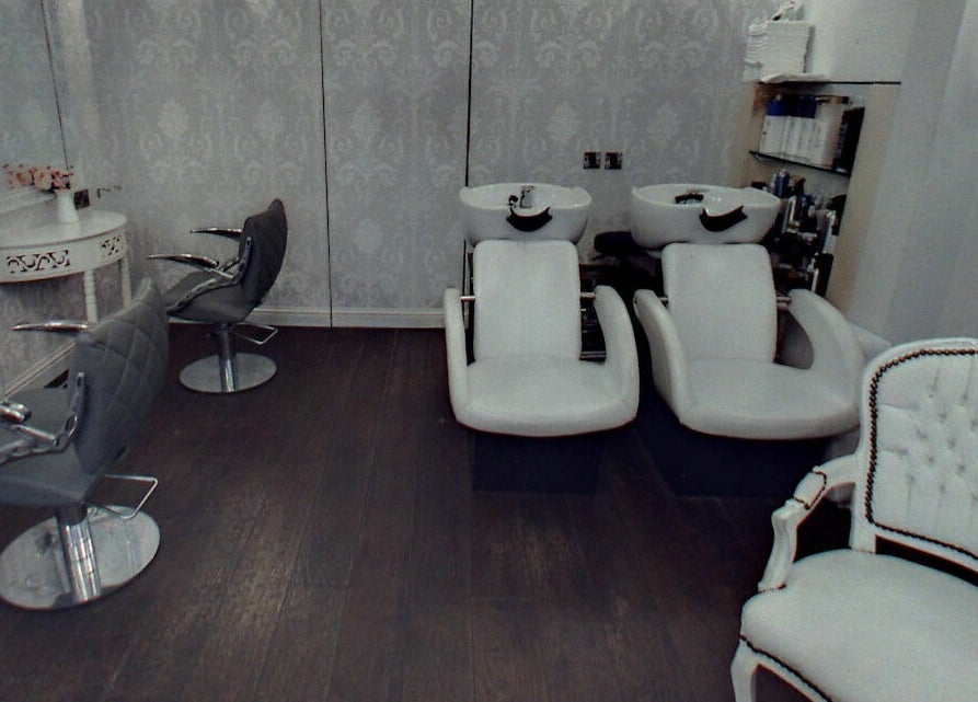 Elegant salon setup at Hair by Boom, featuring modern chairs and wash stations in Edinburgh, Scotland, GB.