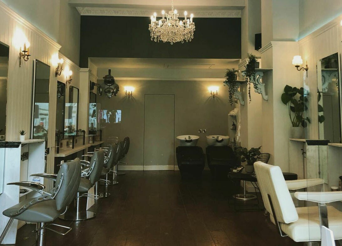 Interior of Hair by Boom, a chic salon in Edinburgh, Scotland, GB with stylish chairs and decor.