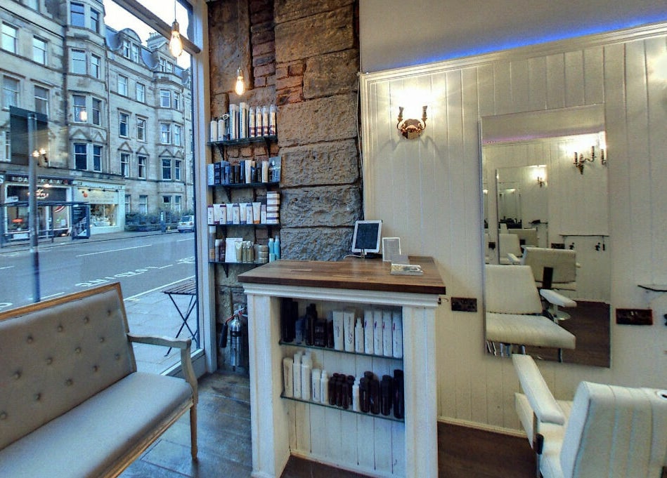 Interior of Hair by Boom salon in Edinburgh, Scotland, GB showcasing elegant seating and a stylish decor.