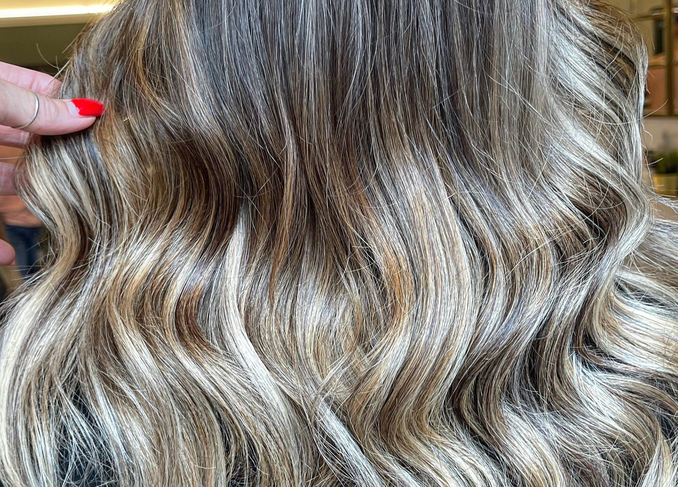 Beautiful wavy hair styled at Hair by Boom, Edinburgh, Scotland, GB, showcasing luxurious texture and color.
