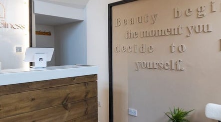 Reception desk at Gaia Wellness in Berkswell, England, GB, featuring a motivational quote on the wall.