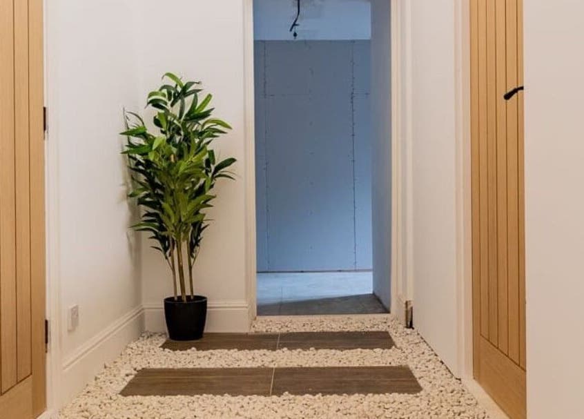Tranquil hallway with plants at Gaia Wellness, Berkswell, England, GB, enhancing a peaceful ambiance.
