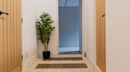 Tranquil hallway with plants at Gaia Wellness, Berkswell, England, GB, enhancing a peaceful ambiance.