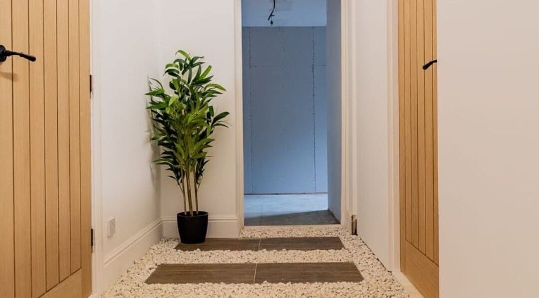 Tranquil hallway with plants at Gaia Wellness, Berkswell, England, GB, enhancing a peaceful ambiance.