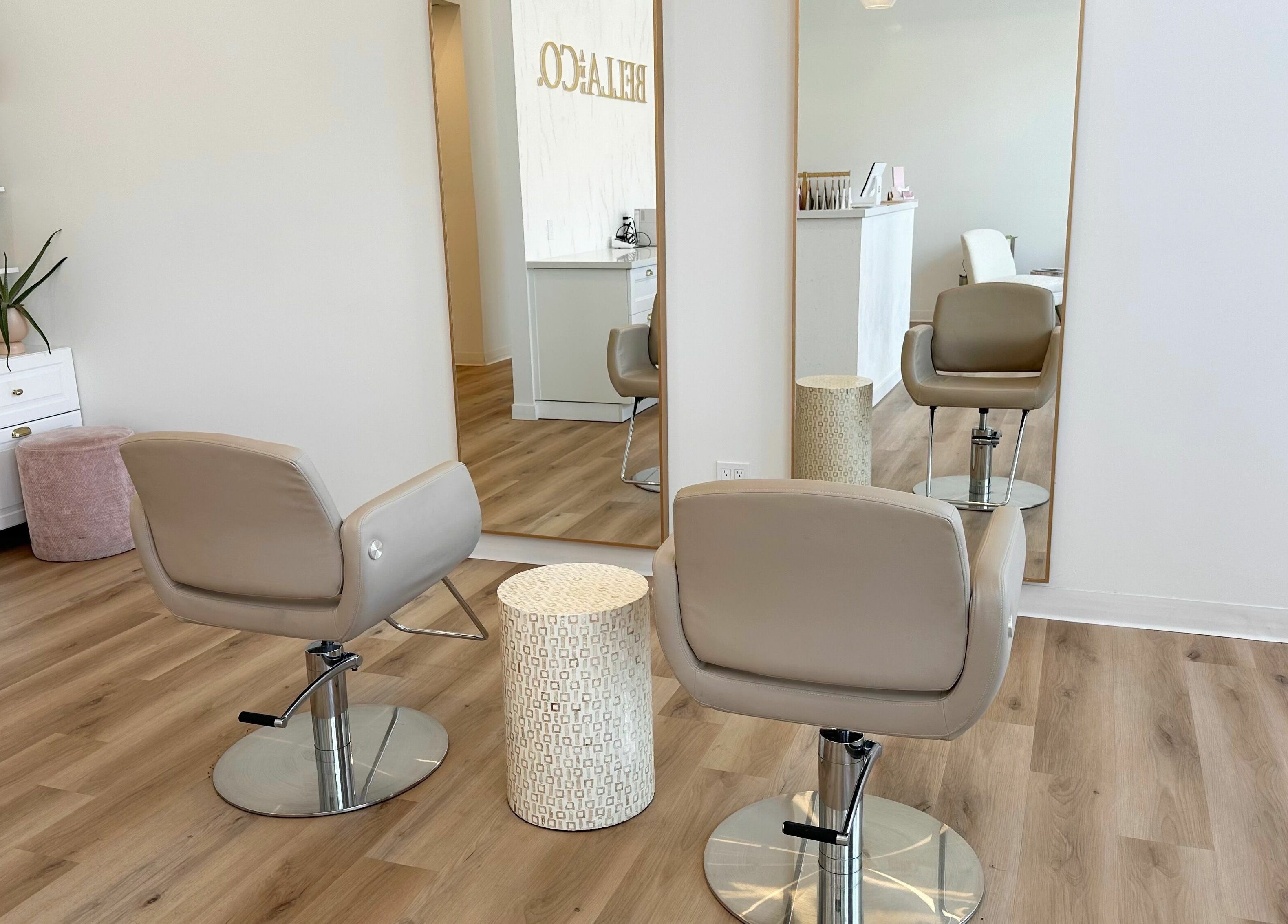 Modern interior of JM Extensions & Academy in Cambridge, Ontario, CA, featuring stylish salon chairs and mirrors.