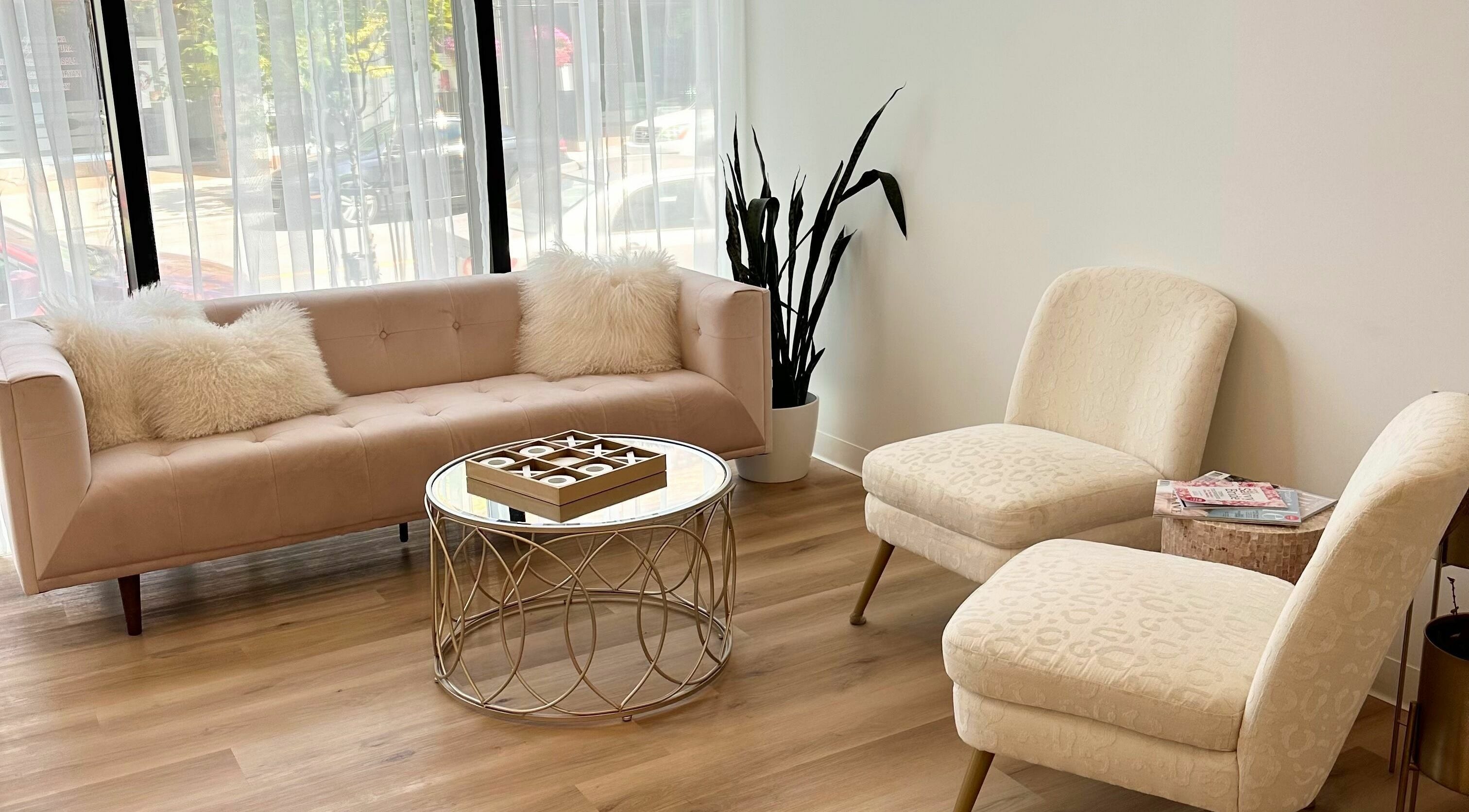 Elegant seating area at JM Extensions & Academy, Cambridge, Ontario, CA with plush chairs and a stylish table.