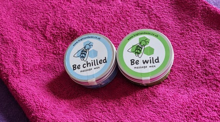 Massage waxes at RENUMI Mind-Body Therapies & Coaching, Musselburgh, Scotland, GB, on a vibrant pink towel.