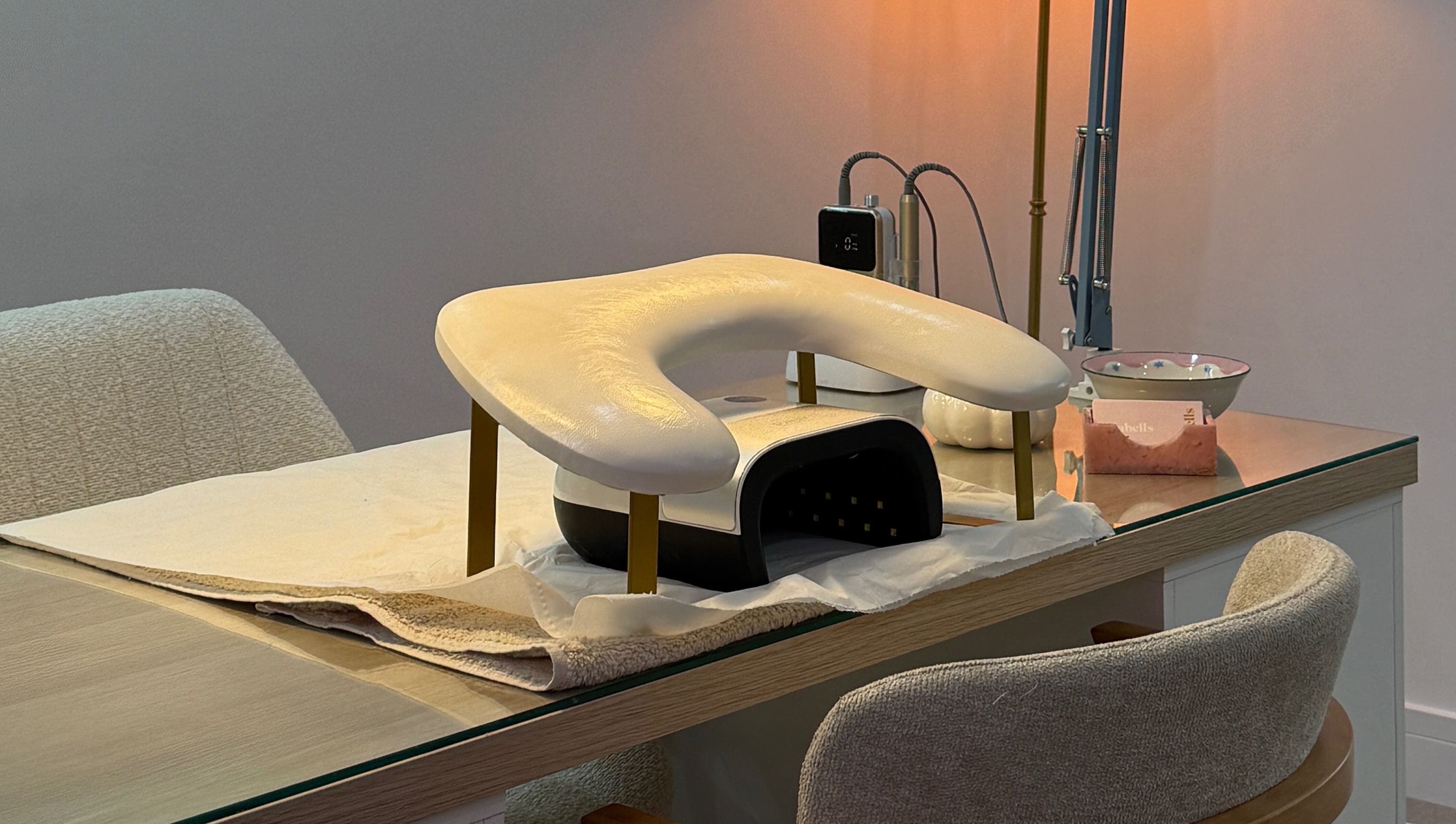 Manicure station at Lulabells Bristol featuring modern nail dryer. Located in Bristol, England, GB.