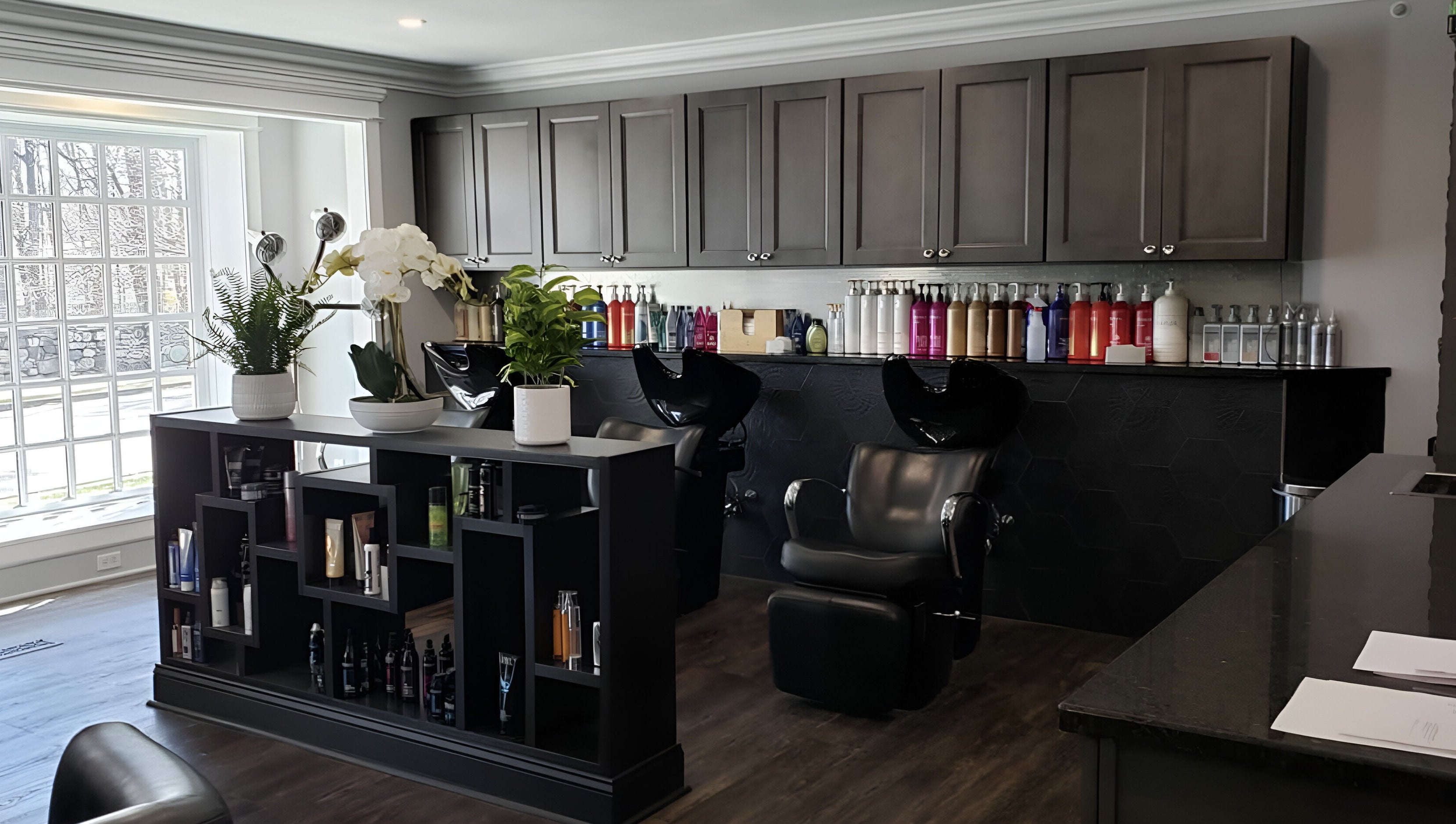 Sophisticated interior of Paris Salon in Ridgefield, Connecticut, US, featuring styling chairs and product display.