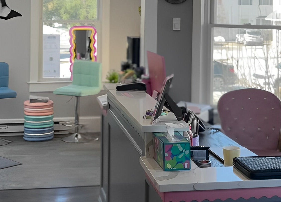 Trendy reception area at Paris Salon, Ridgefield, Connecticut, US with pastel decor and modern seating.