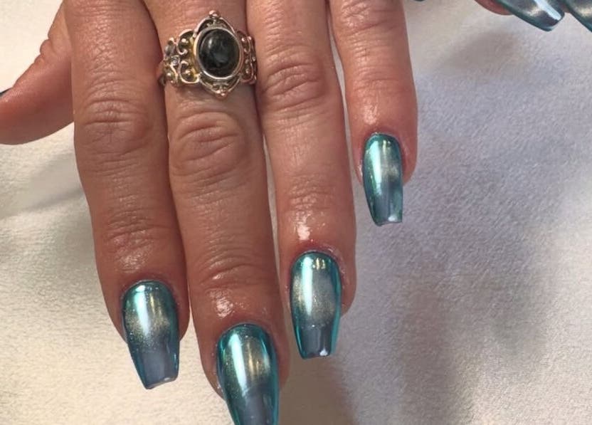 Sparkling blue nails with silver highlights at Paris Salon, Ridgefield, Connecticut, US.